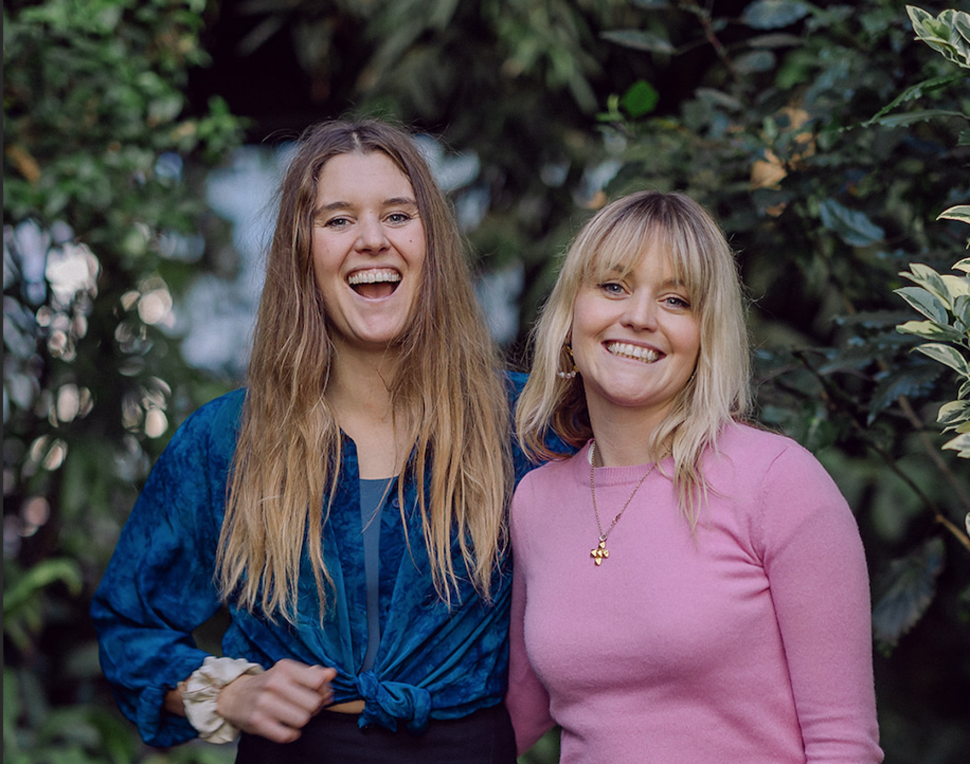 An image of Earthed co-founders, Christabel and Ruby Reed, standing in the lush backdrop of The Barbican in London.
